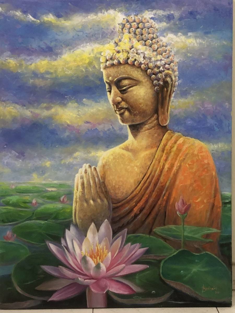 Buddha in an orange robe with lotus